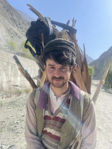 A shepherd with a woven basket on his back